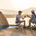 un couple avec une bière à la main dans un camping